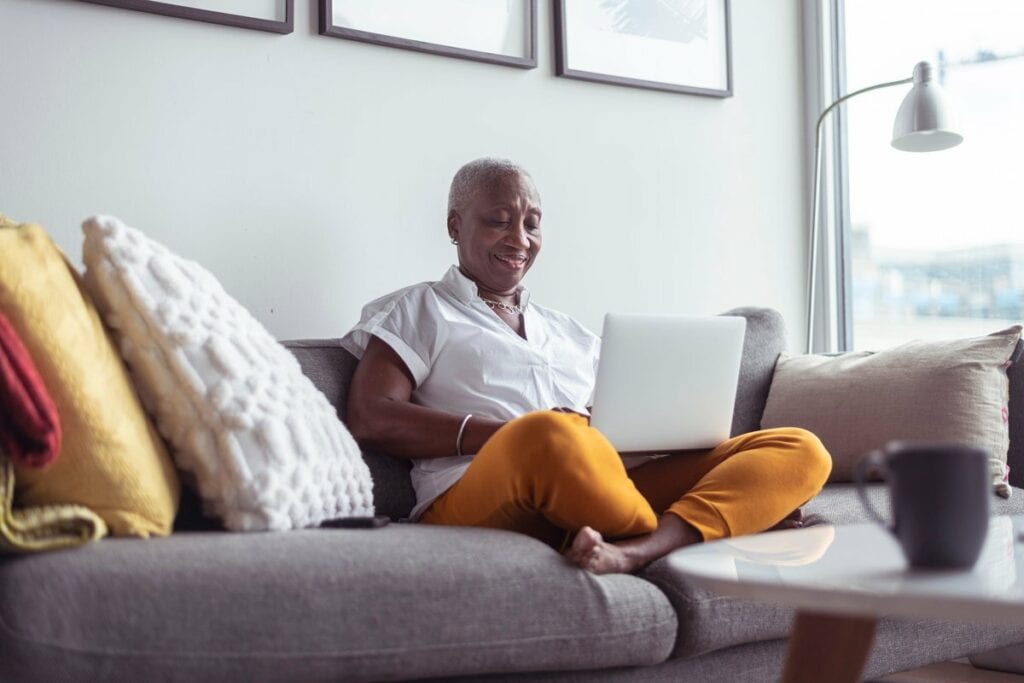 older adult on couch with laptop nNXo.width .jpg