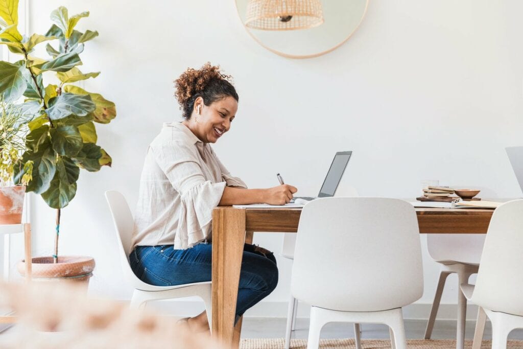 person at dining table writing in notebook TR.width .jpg