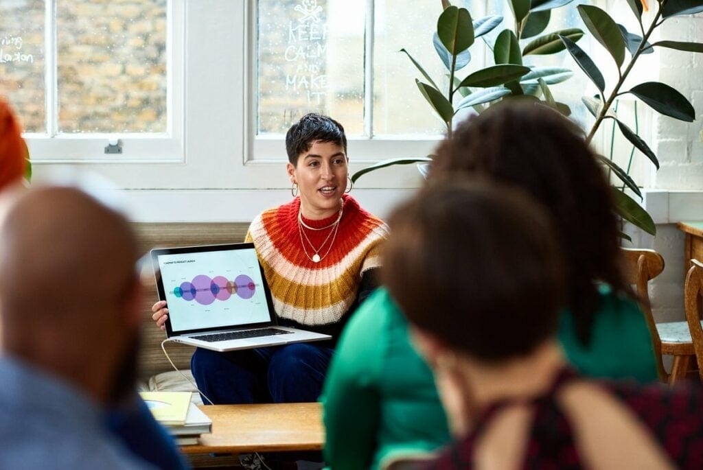 person leading meeting in office with laptop .width .jpg
