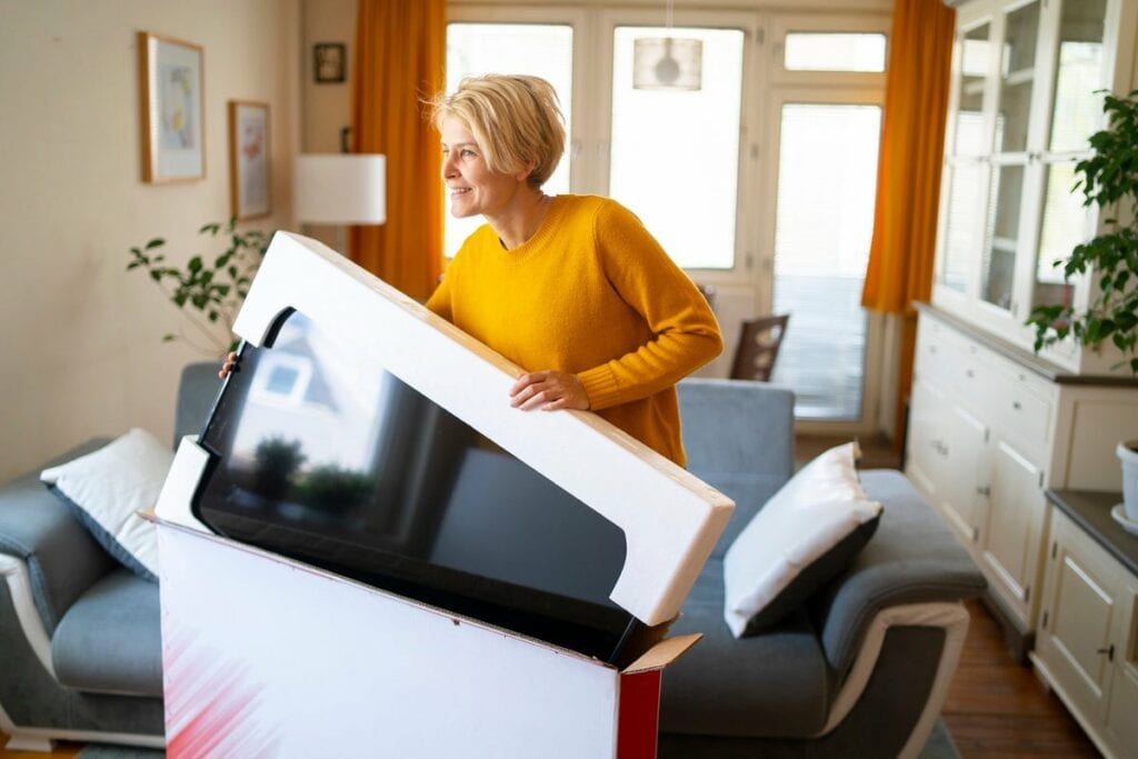 person unboxing new tv iIIanrE.width .jpg