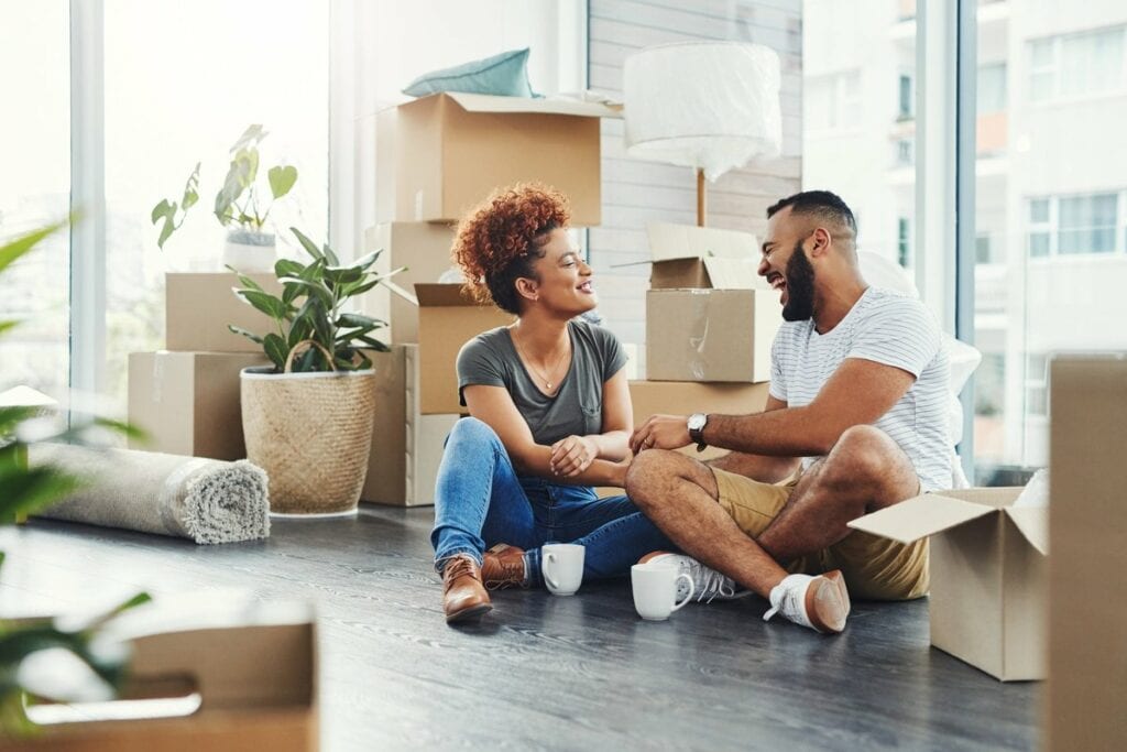 two people on floor between moving boxes kVBB.width .jpg