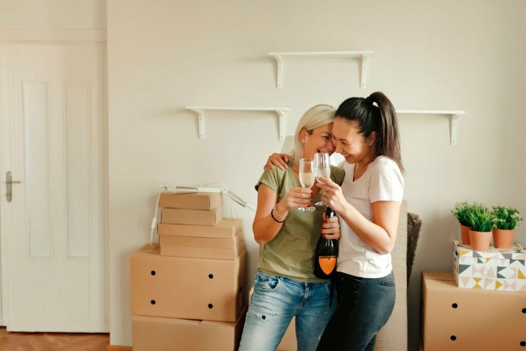 two people with champagne and moving boxes T.width .jpg