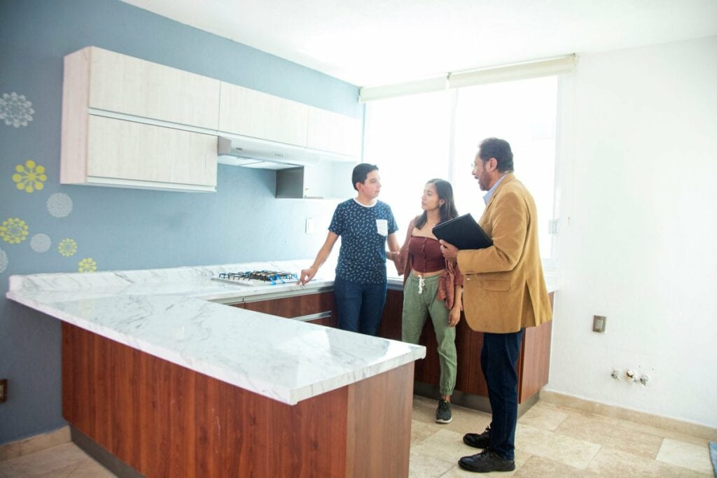 two people with realtor in kitchen XaHTHIU.width .jpg