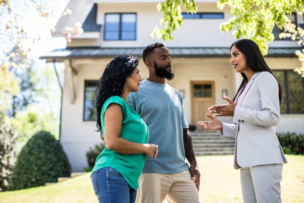 two people with realtor outside house KeFovDR.width .jpg