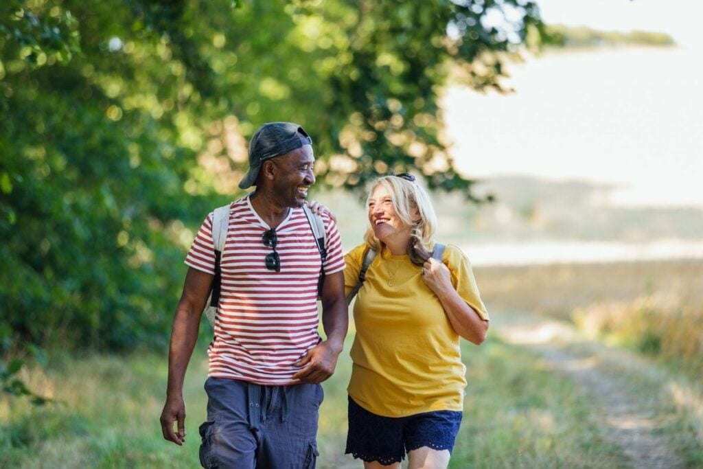 two smiling people hiking pHjfNub.width .jpg