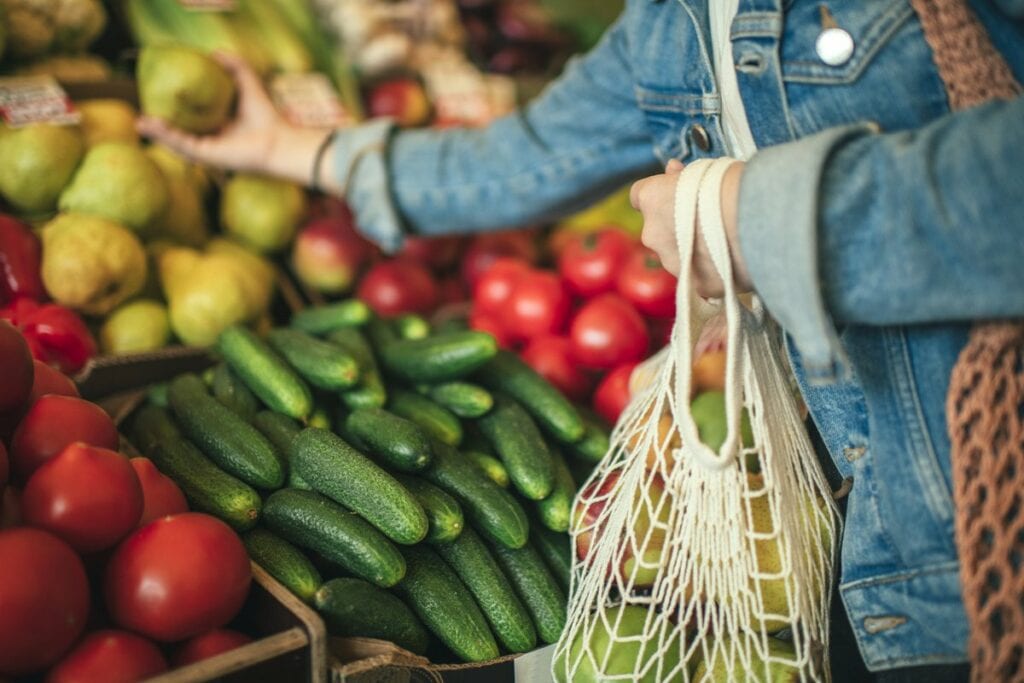 woman buying produce at grocery store.width .jpg
