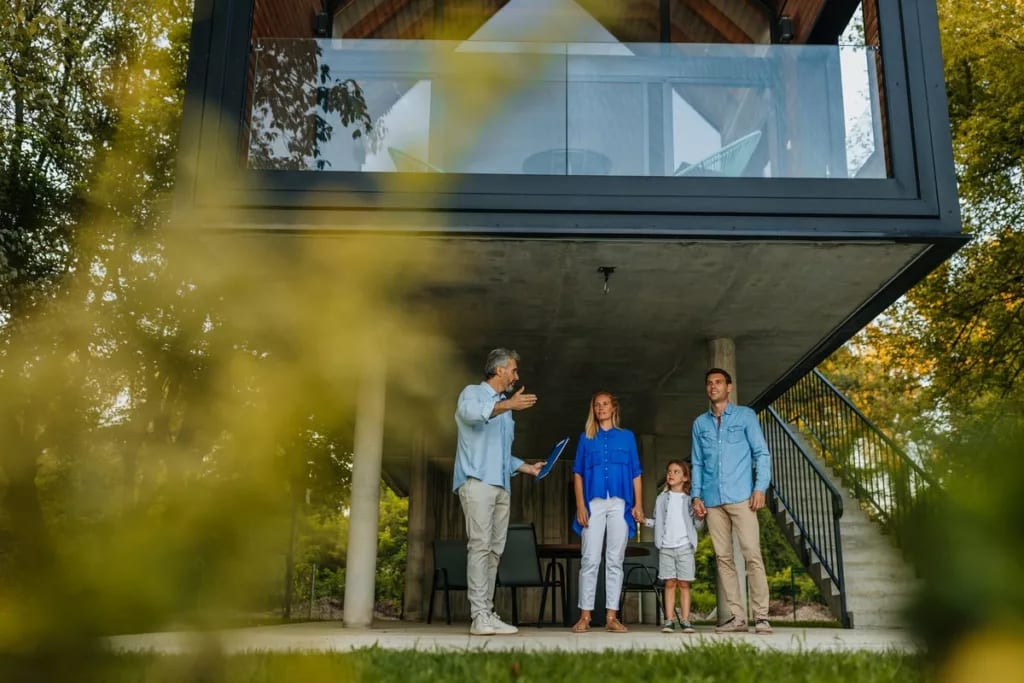 Family talking to realtor by extra modern hom.width jTPPh.jpg