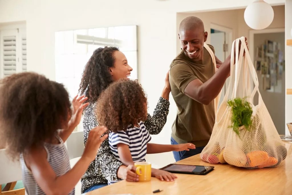 Father bringing home groceries to family.width .jpg