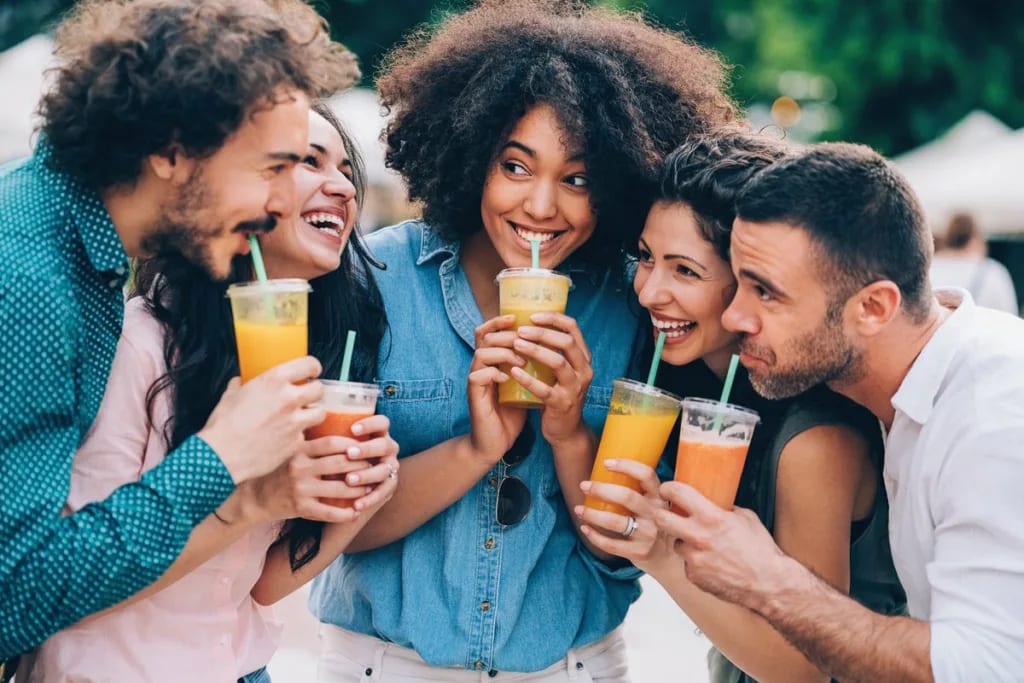 Group of friends drinking juice outdoors. xRC.width .jpg