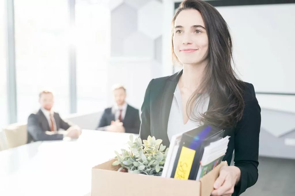 Happy businesswoman leaving job with box of b.width qZUZkS.jpg