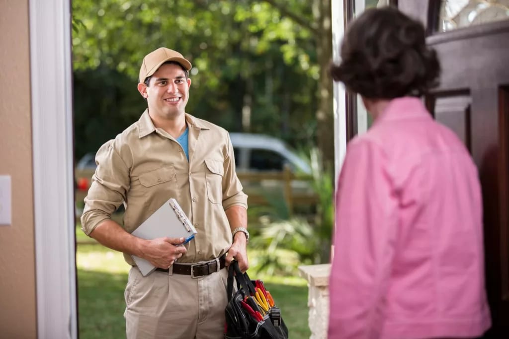 Homeowner opening the door for repairman HJP.width .jpg