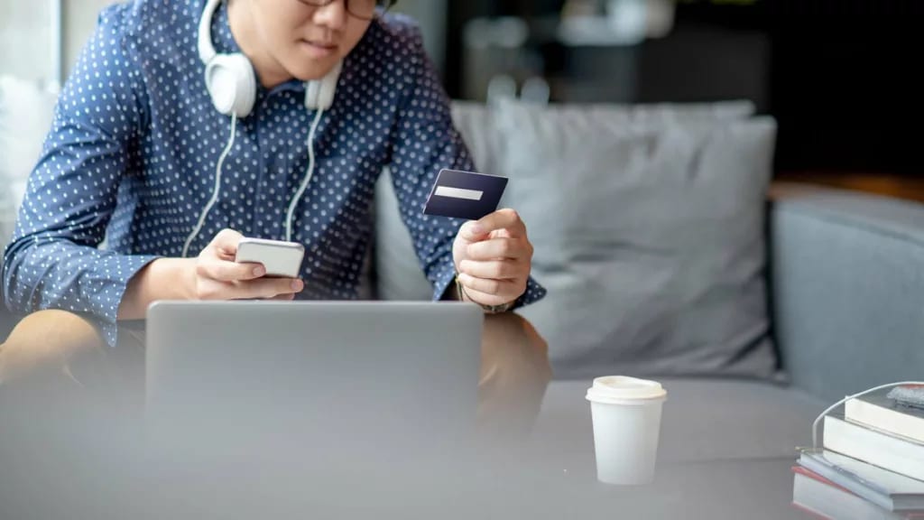 Man with credit card phone laptop TGXVGqd.width .jpg