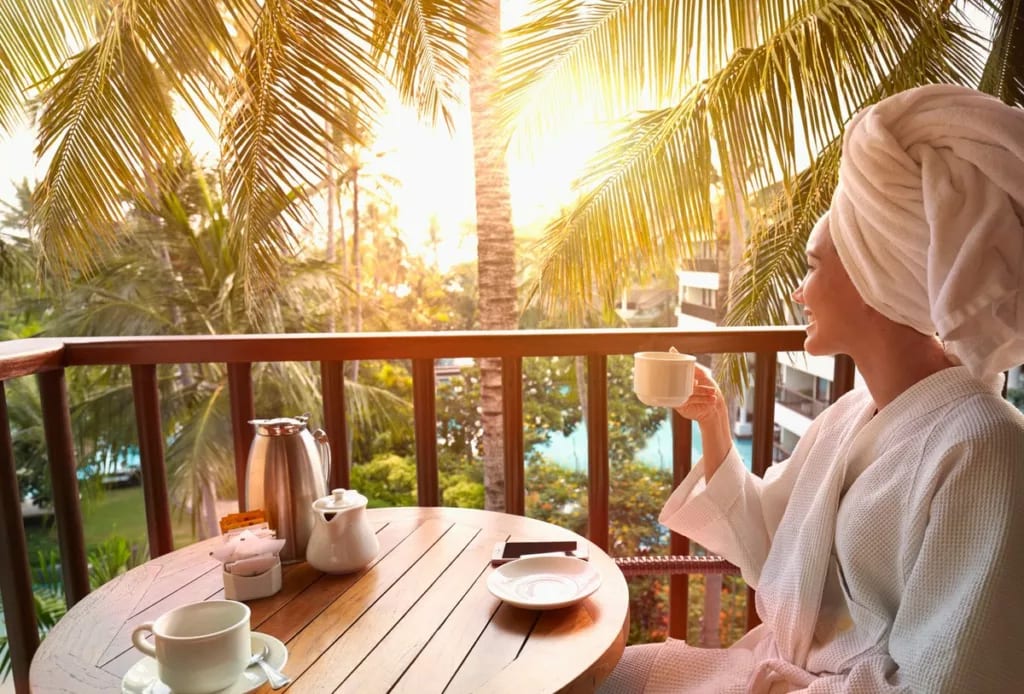 Woman in robe drinking coffee on balcony at t.width XIPpxO.jpg