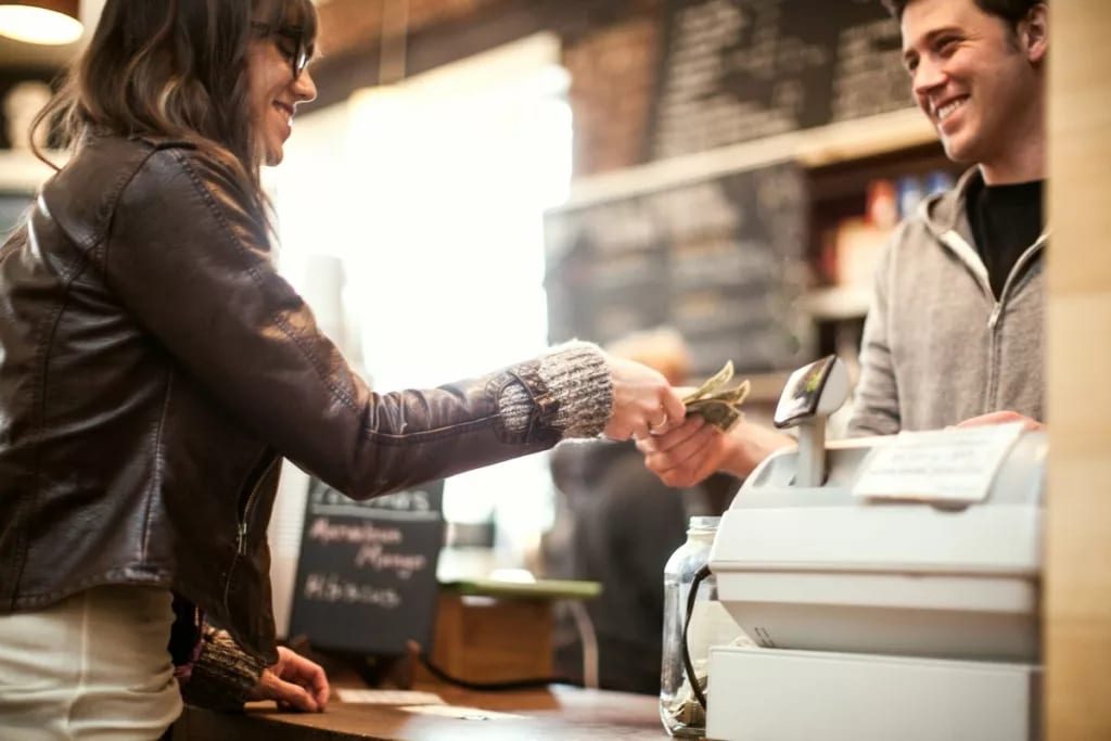 Woman paying for purchase with cash. VMjwvr.width .jpg