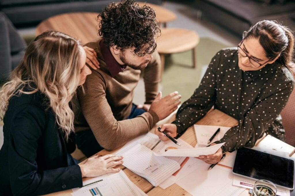 Young couple going over paperwork with female.width hAKGlR.jpg