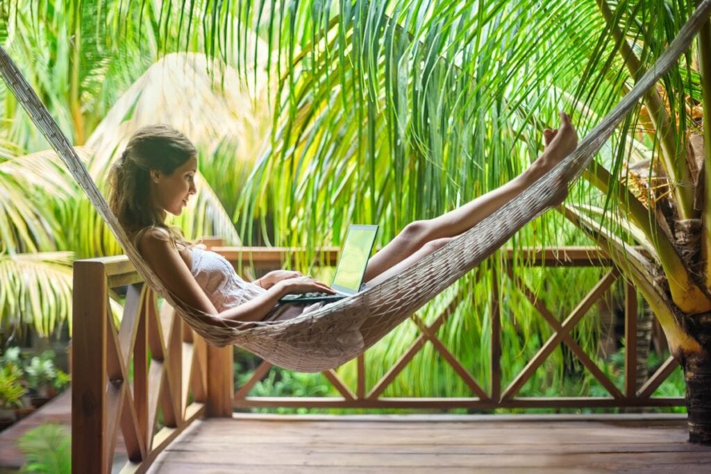 digital nomad using a laptop in a hammock sur.width XuhacNK.jpg