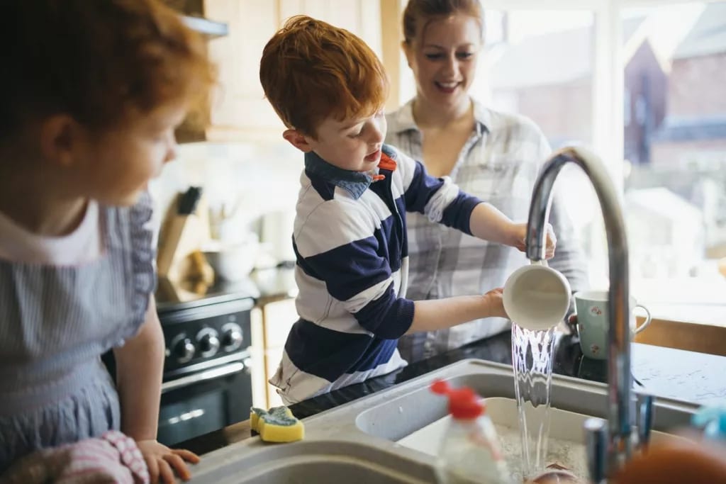 mom and two kids washing dishes.width .jpg
