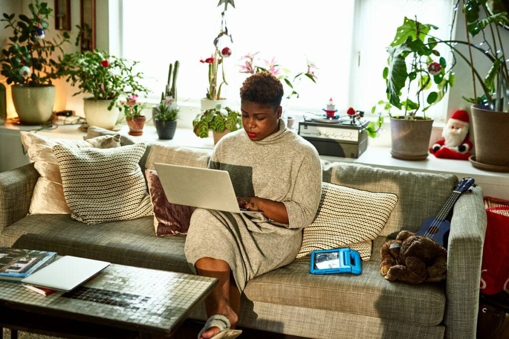 person on couch on laptop uUczik.width .jpg