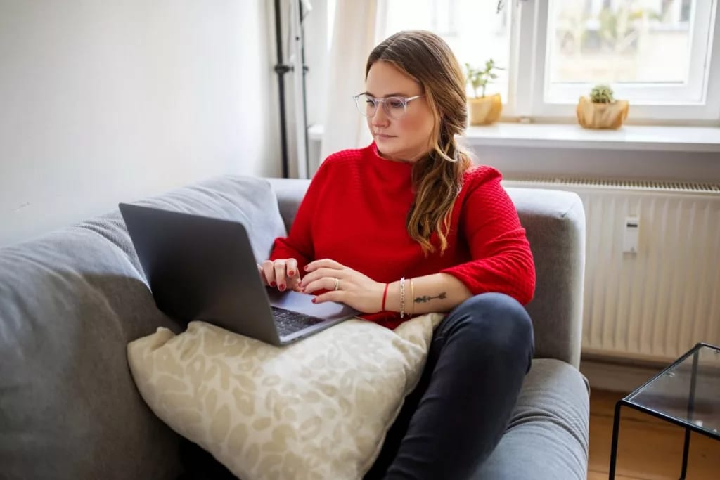 person on couch with laptop NhPfiGo.width .jpg