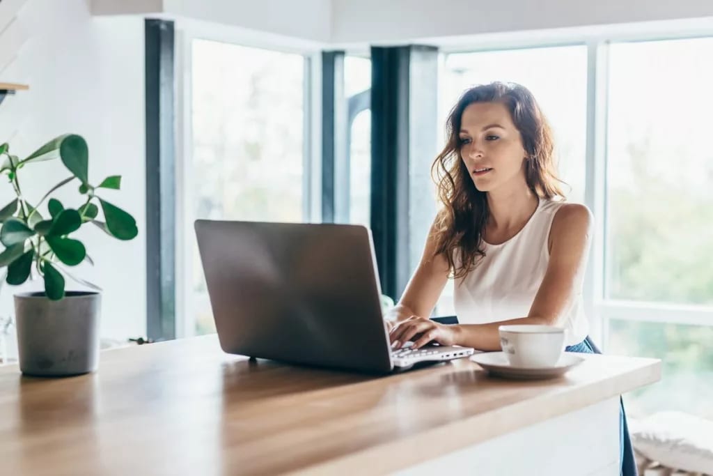 person on laptop at dining table aUpw.width .jpg