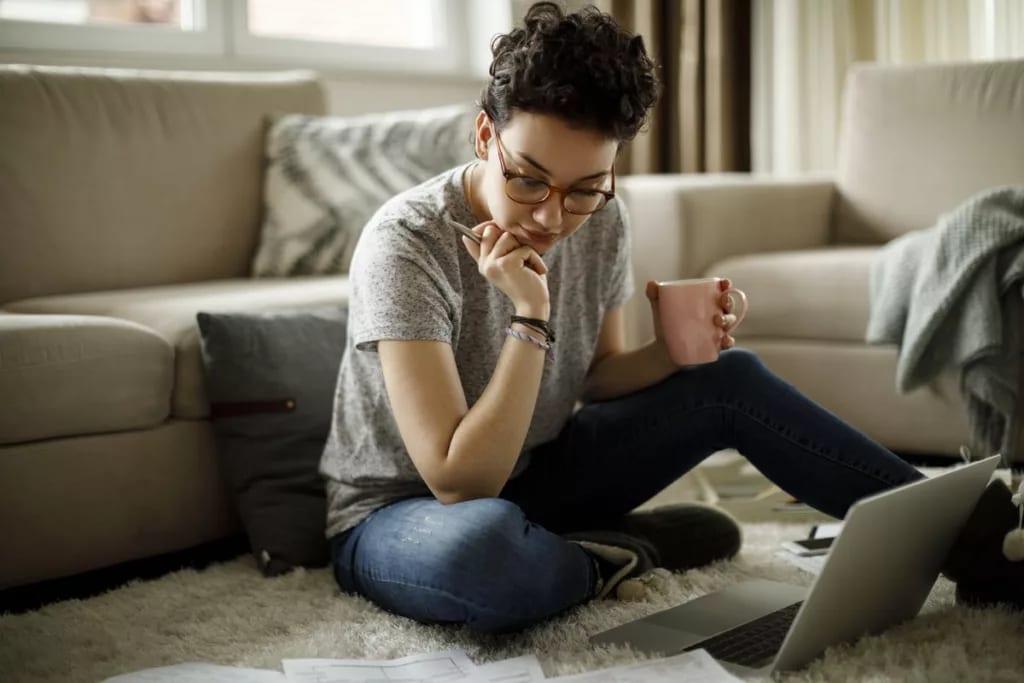 young woman on floor with laptop FoAMBbr.width .jpg