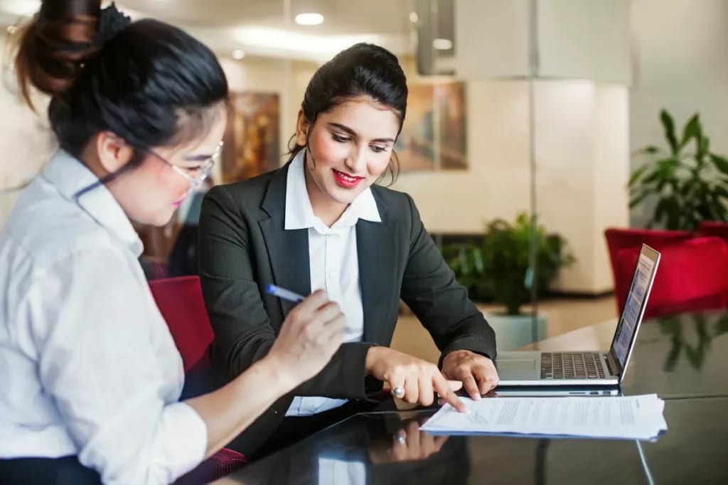 Bank employee and customer signing documents .width WrzFB.jpg