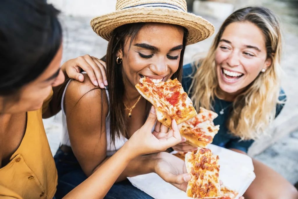 Group of friends enjoying pizza together. Ps.width .jpg