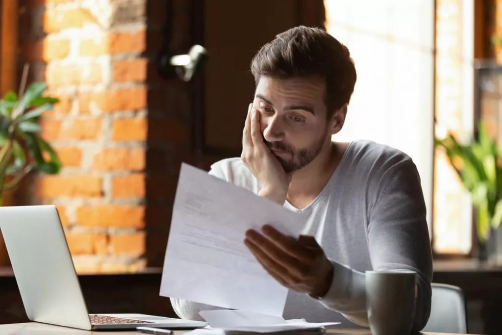 StressedOutGuyLookingAtPaper.width .jpg