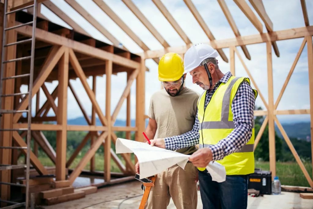 Two builders review blueprints inside an in p.width WEbpsh.jpg