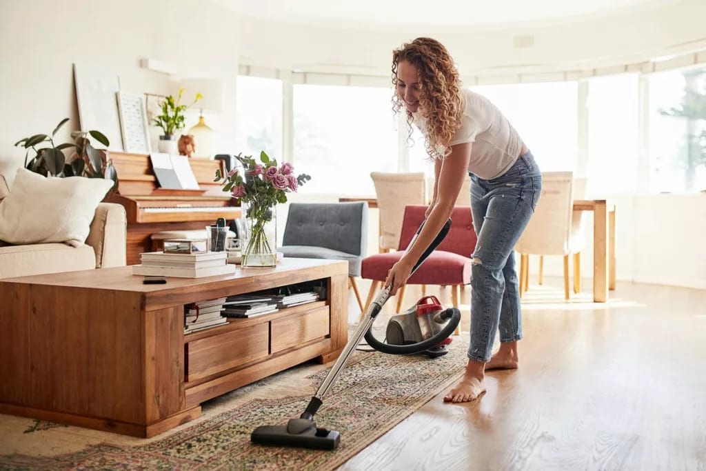 Woman vacuuming her living room QCsTI.width .jpg