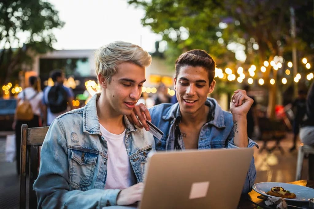 Young couple sit outdoors credit card MHYcYn.width .jpg