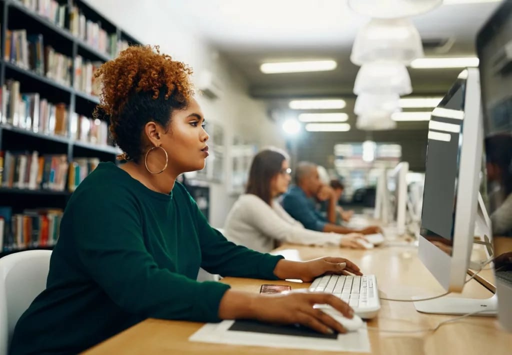 Young woman using laptop at the library slDaC.width .jpg