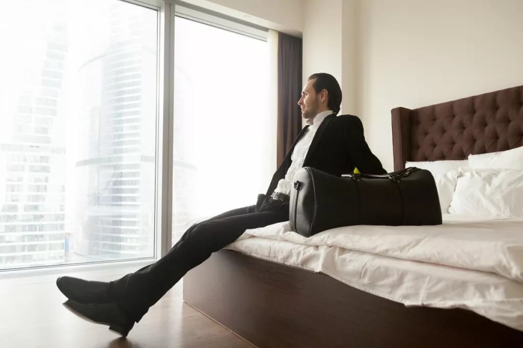man in suit on hotel bed GCmlvmw.width .jpg