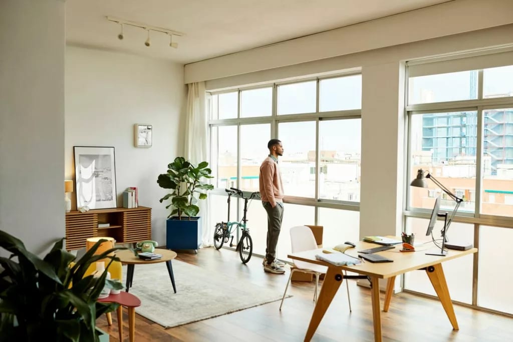 person looking out apartment window PwKvtj.width .jpg