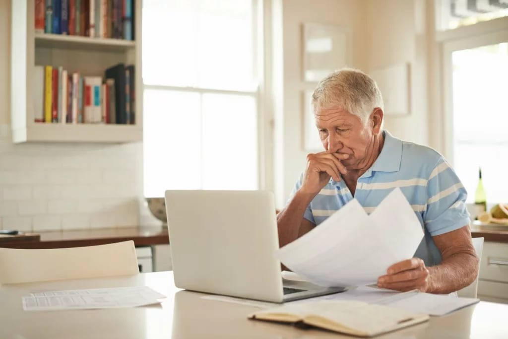 stressed person with papers and laptop UsCv.width .jpg