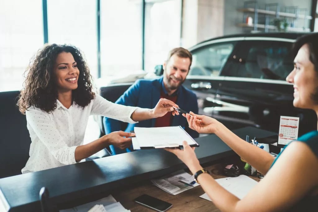 two people buying car from salesperson bfeJF.width .jpg