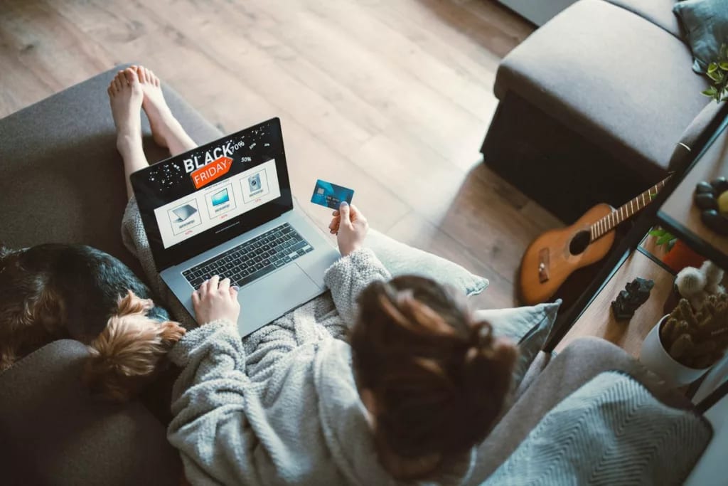 Woman black friday shopping from her couch at.width vuMiEiu.jpg