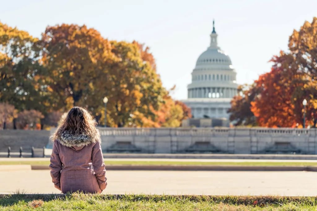Woman sitting outside the capitol building on.width jUkdkxR.jpg