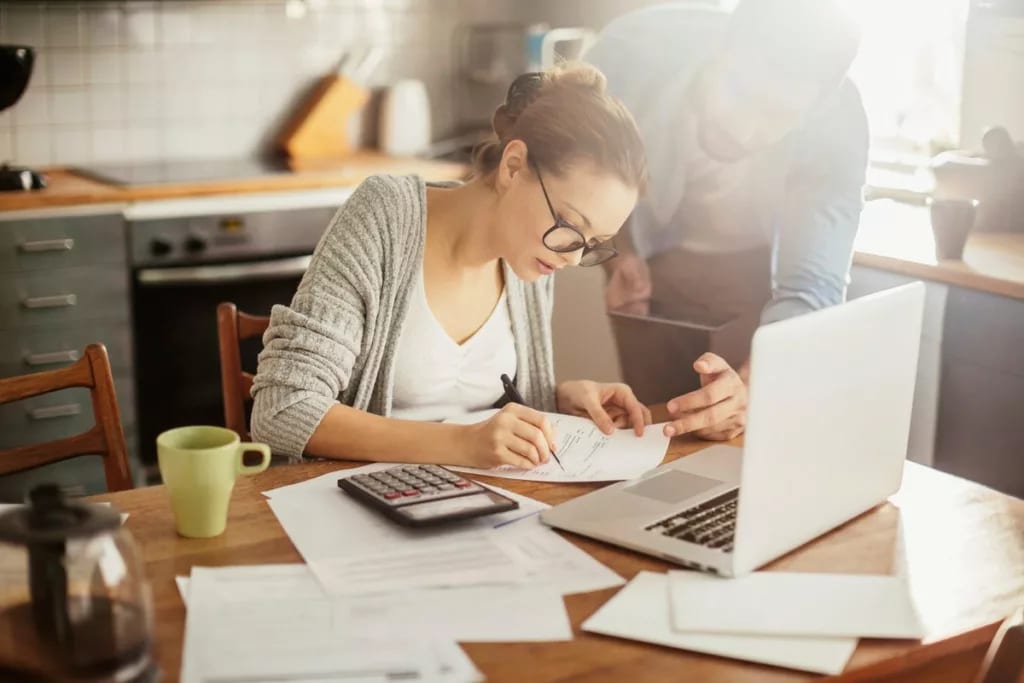 Woman with glasses making calculations VoscoL.width .jpg