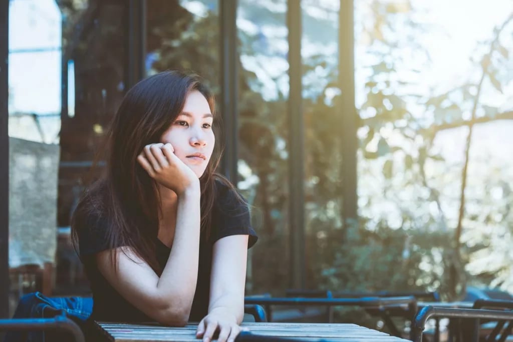 Young woman looking thoughtful UiTwxx.width DWzGXu.jpg