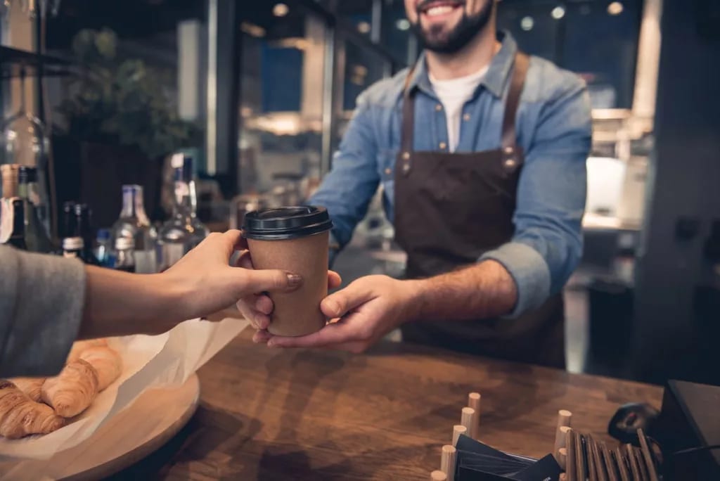 barista handing coffee to customer UySMQTH.width .jpg
