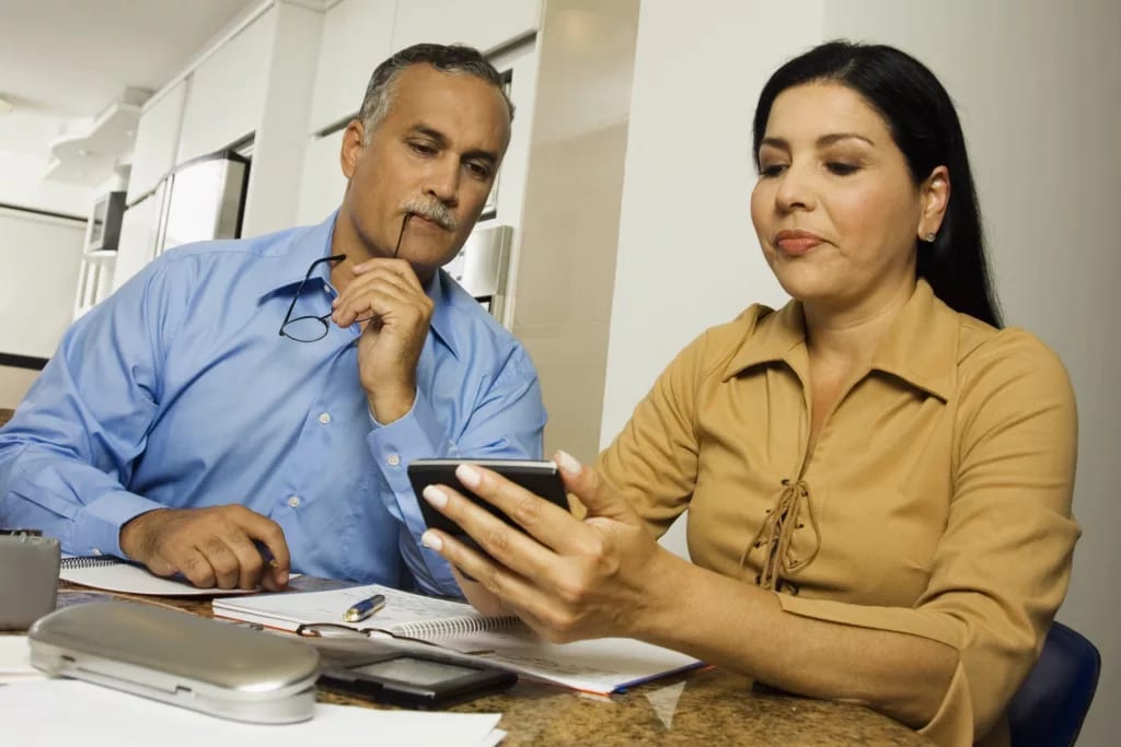 middle aged couple with calculator.jpg