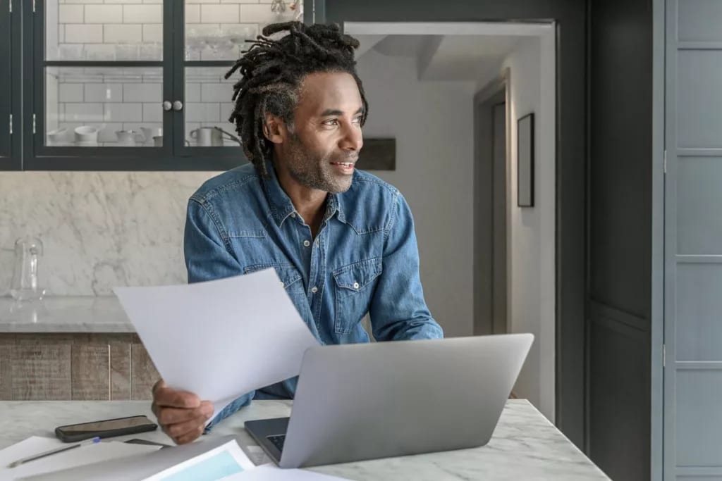 person at kitchen counter with laptop oDMjYzA.width .jpg