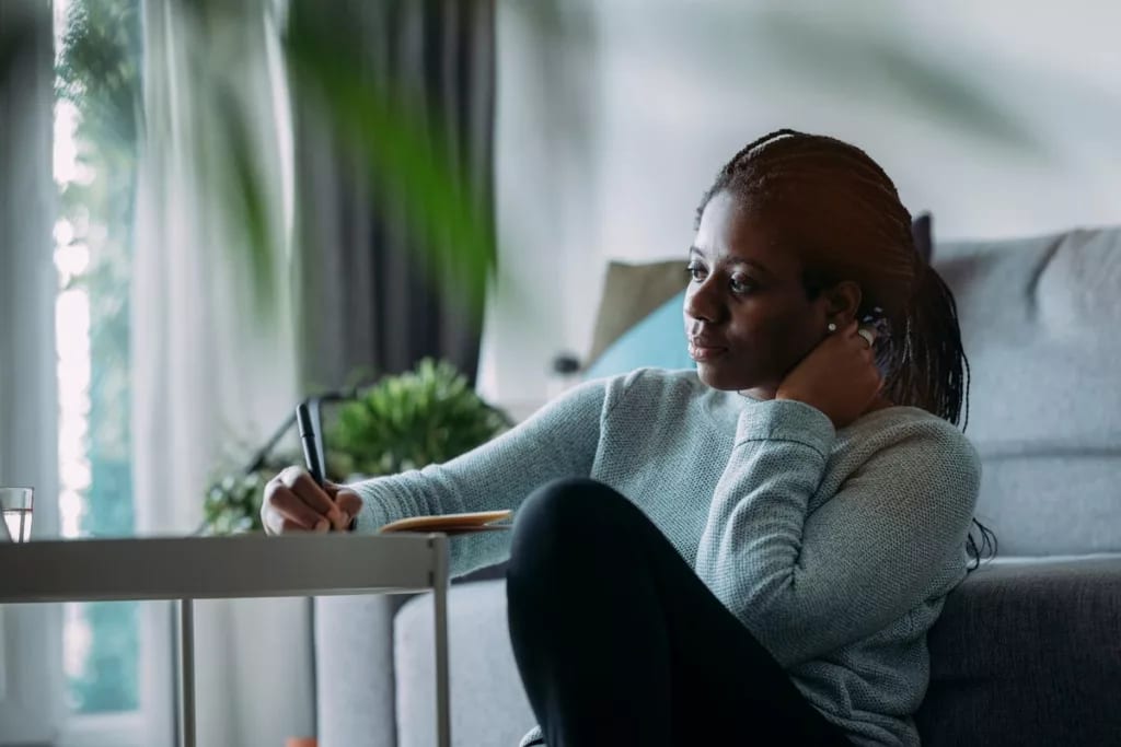 person writing in notebook at home wtymJ.width .jpg