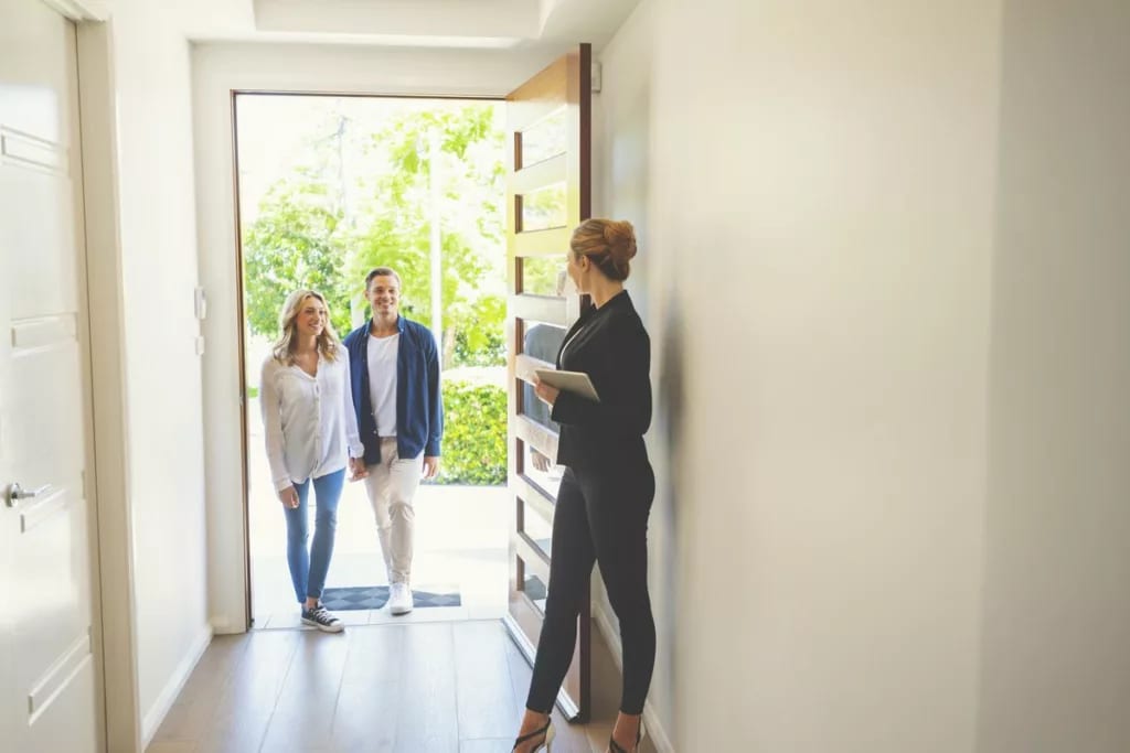 realtor and couple in home.width .jpg