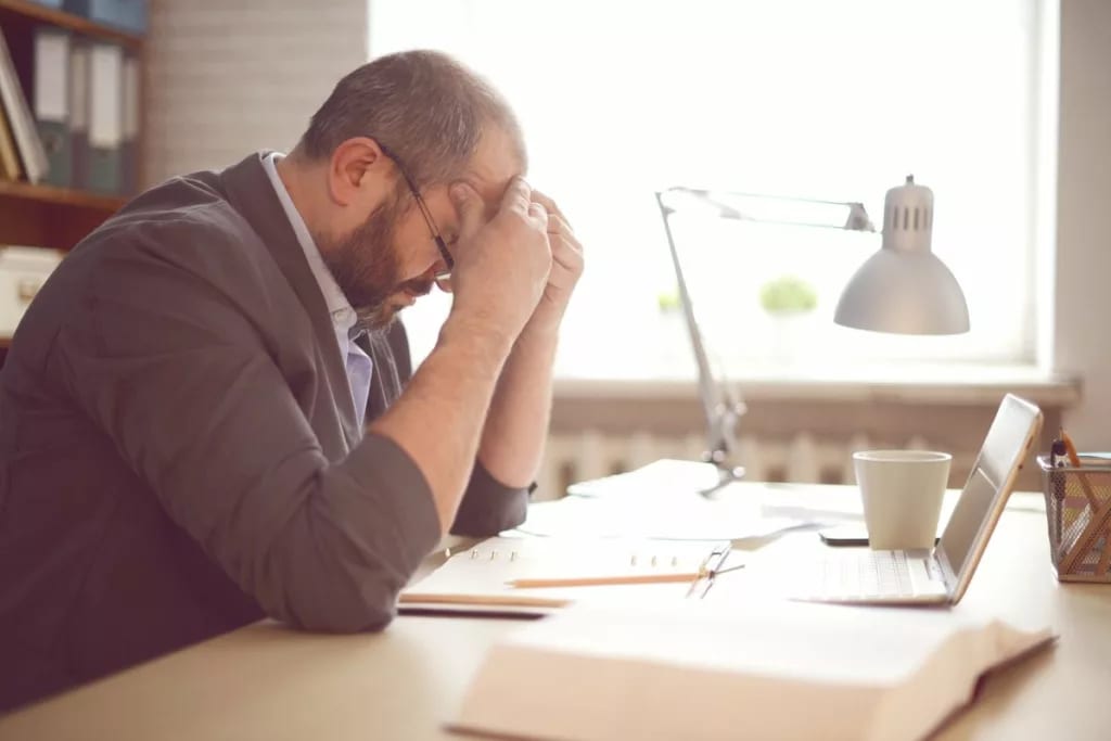 stressed man working at desk kJlAx.width .jpg
