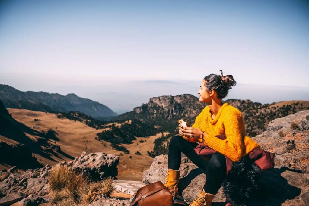 woman resting on hillside hike clGvh.width .jpg