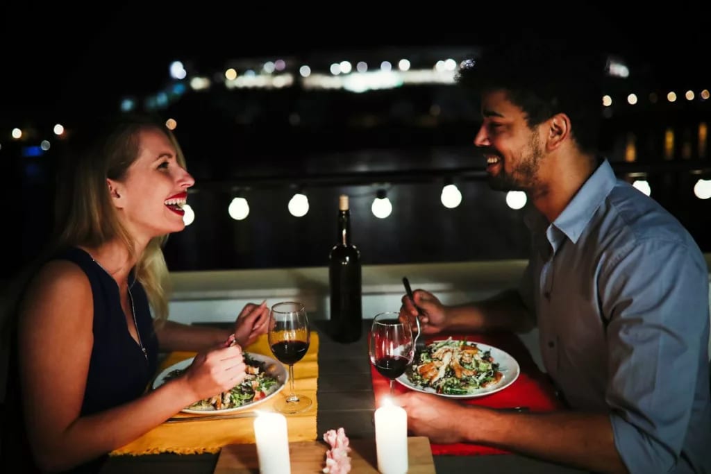 young man and woman sitting at table eating d.width xnzmD.jpg