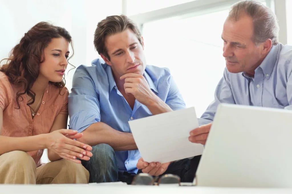 Mature man going over paperwork with young co.width iTNbwX.jpg