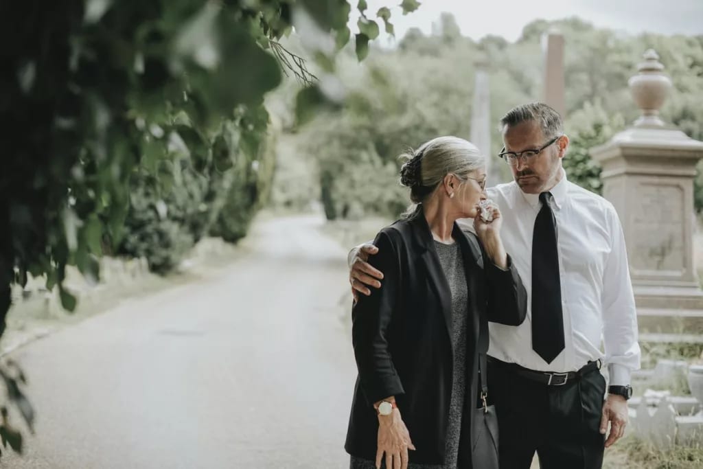 man comforting woman at funeral.width .jpg